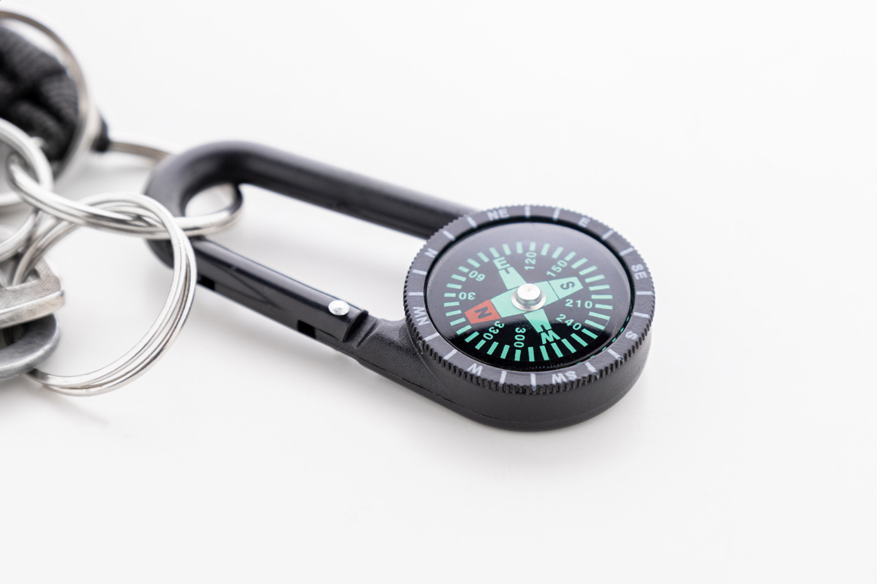 Kompassi avaimenperä logolla.